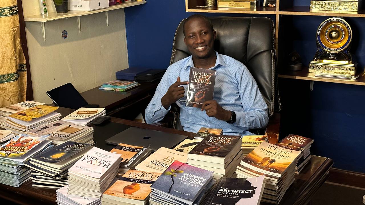 Pastor Emmanuel Mukisa with his published books